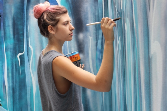 Jenni Tyler painting a mural
