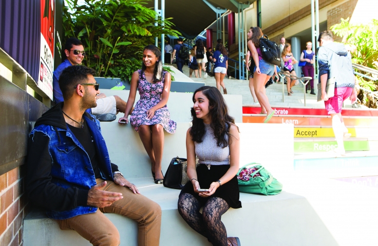 Group of UNSW students sitting on steps laughing