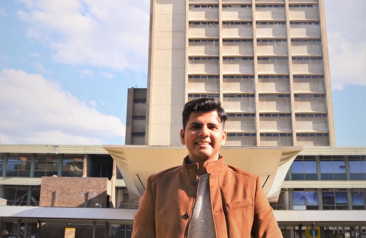 UNSW student Saurabh in front of the library building